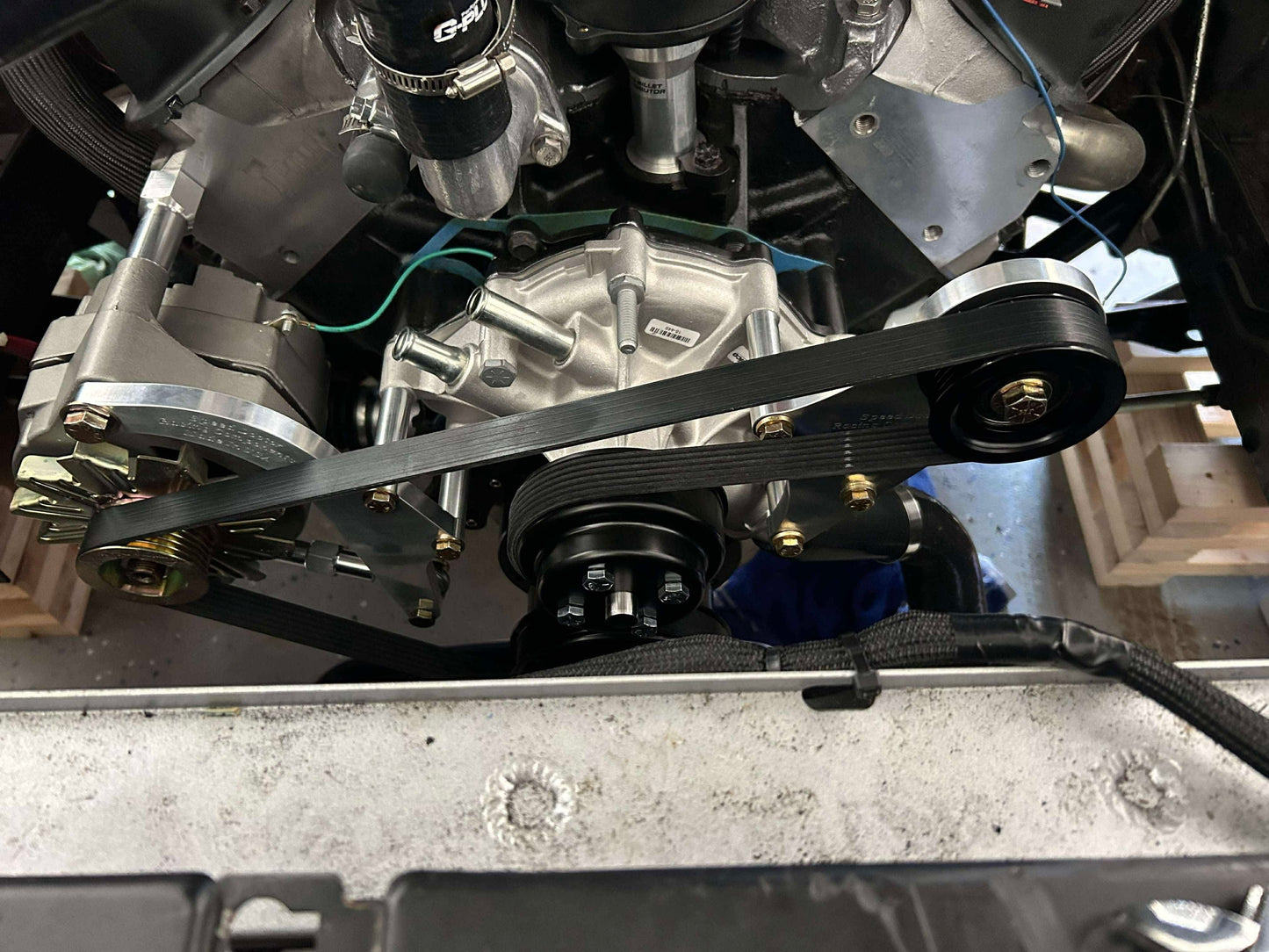Vehicle engine bay showing installed AC delete kit