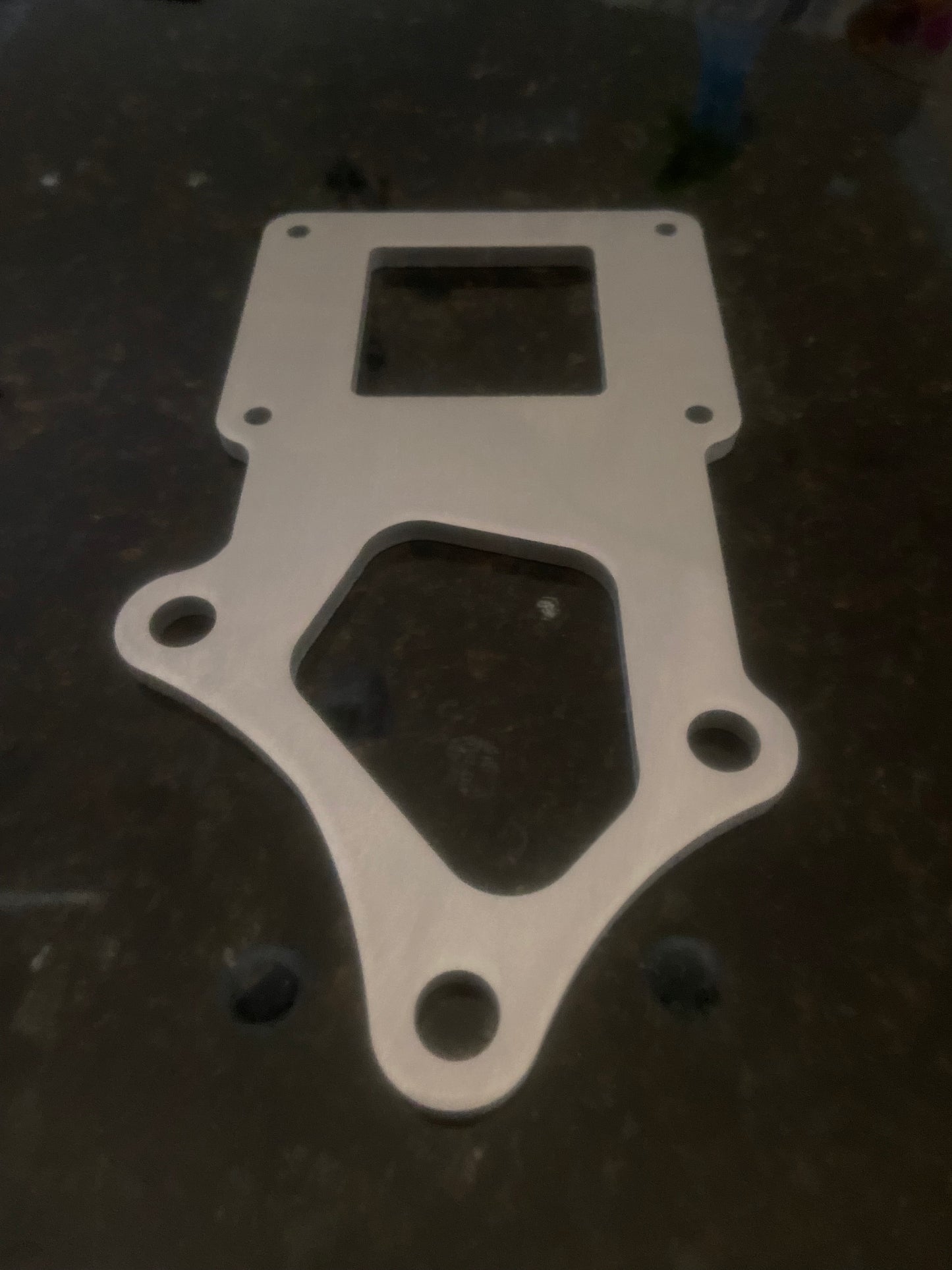 Aftermarket ignition coil bracket for automotive use